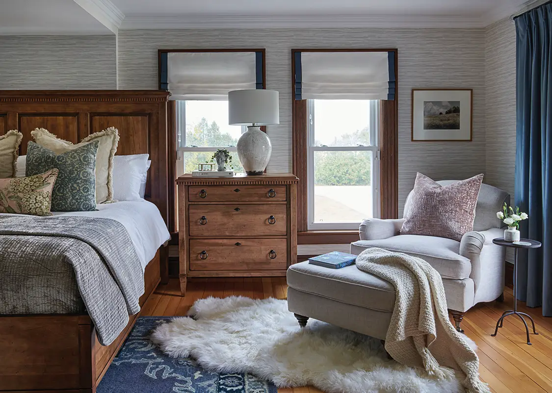 gray grasscloth wallpaper in neutral bedroom with oak headboard and dresser