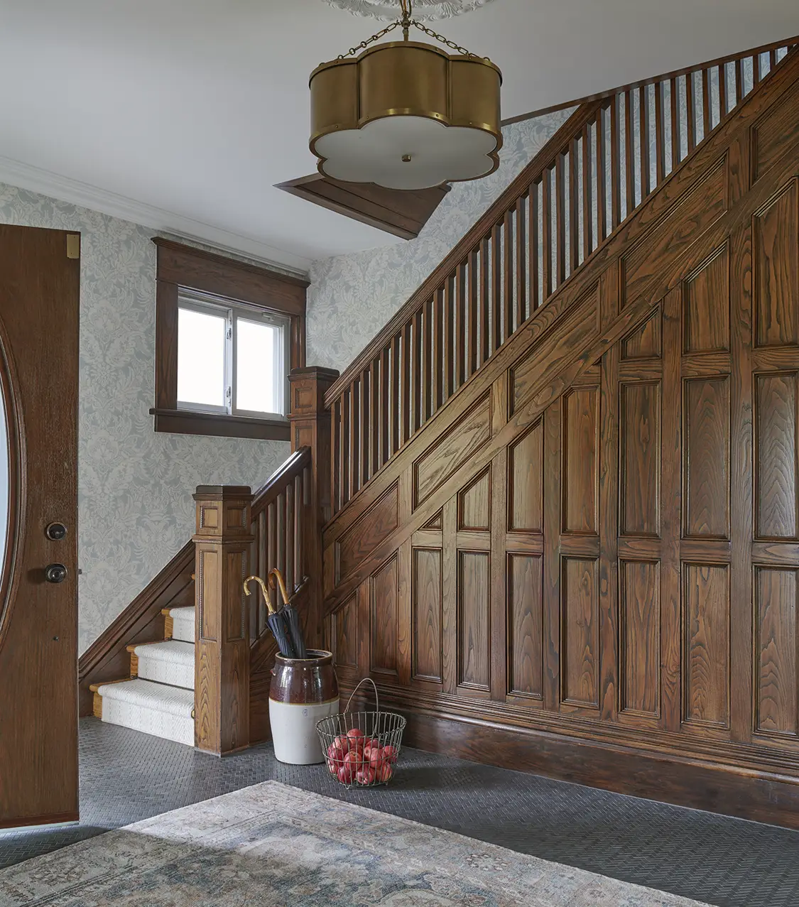 coffered staircase with traditional bannister and damask wallpaper in Craftsman Victorian farmhouse