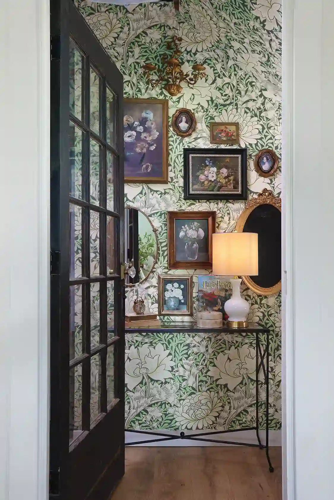 nook with botanical wallpaper and still life floral paintings