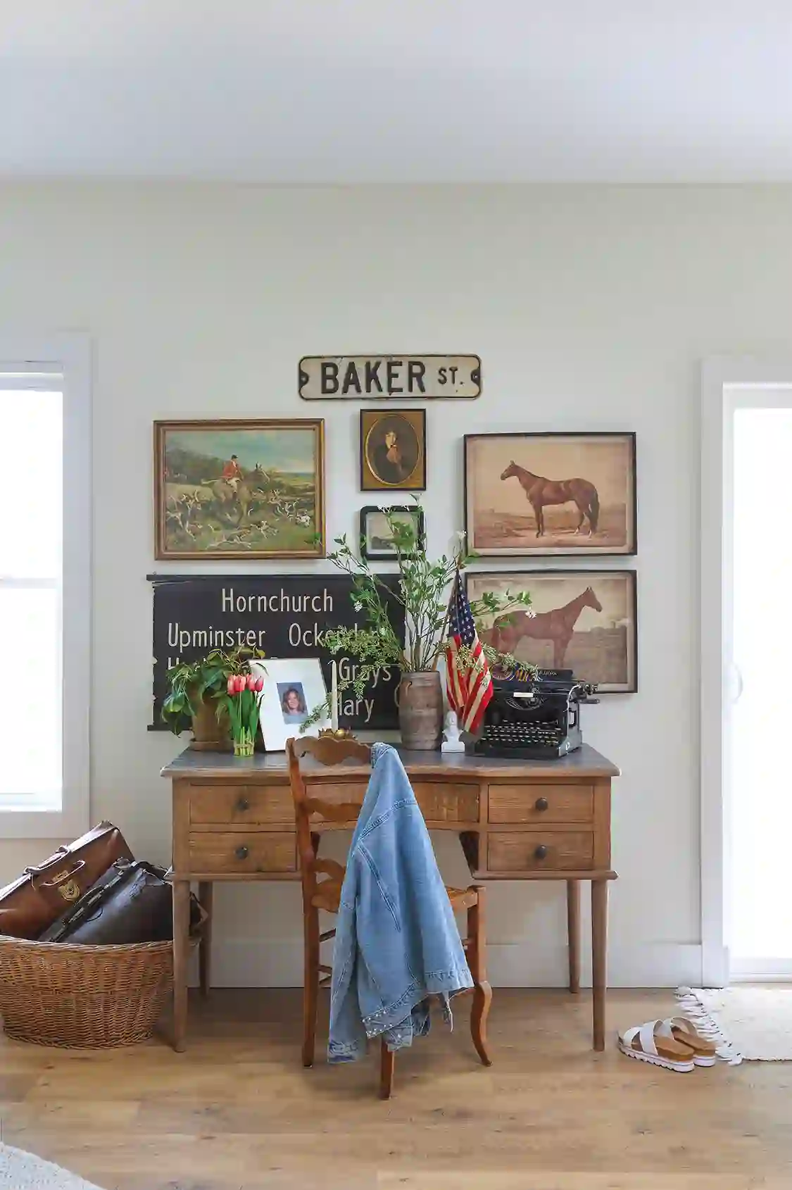 vintage horse paintings and typewriter above desk in expansive dream home