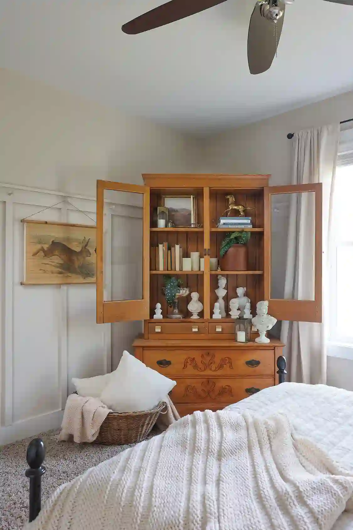 bookcase with collection of vintage books and white busts