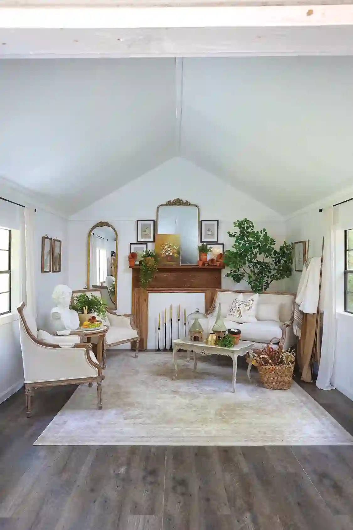 she shed with white vintage style furniture and candles in lieu of fireplace