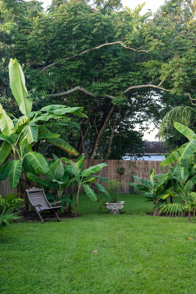 sitting area in lush Florida garden part of 1890 farmhouse property