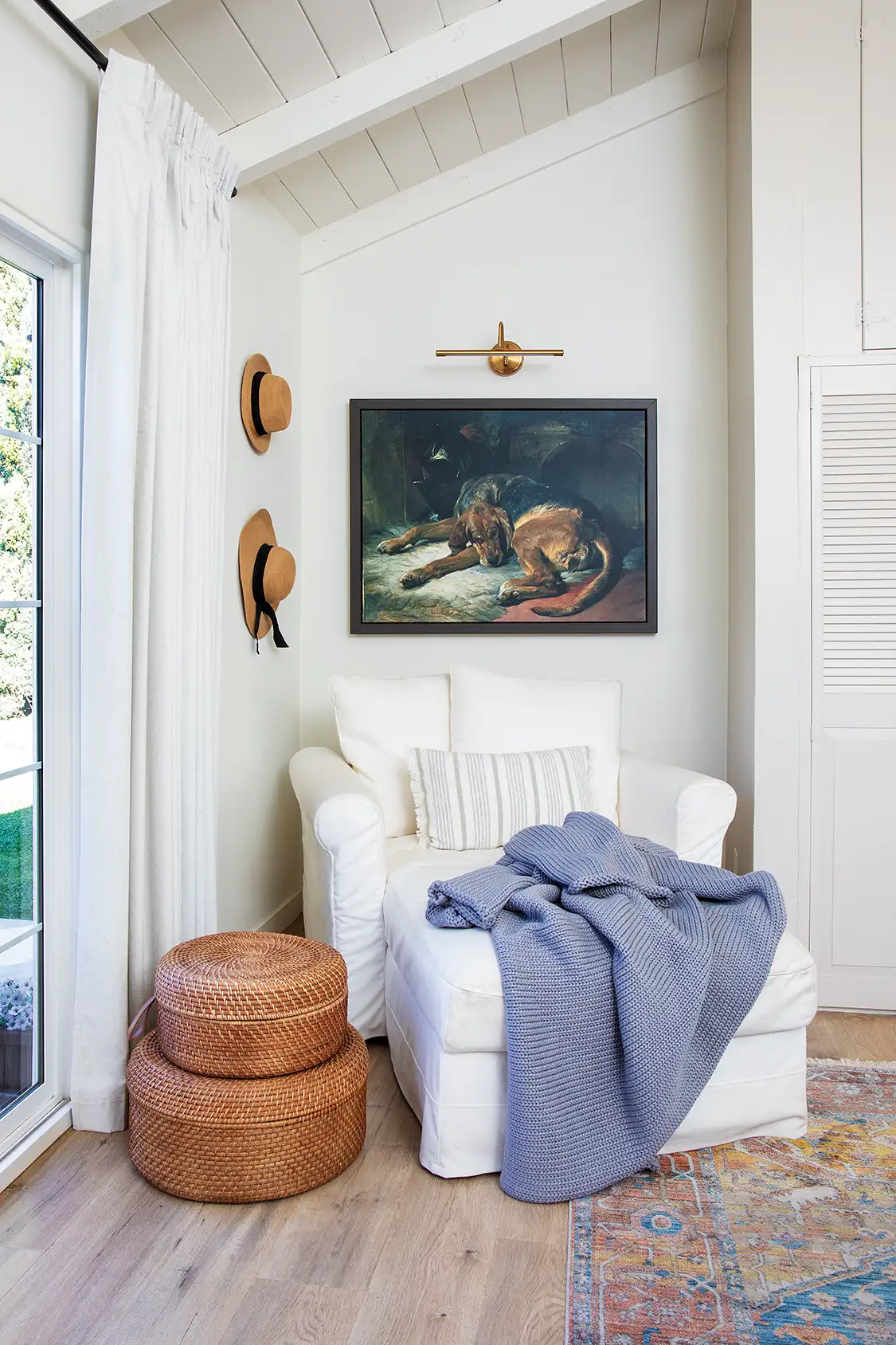 reading corner with painting of dog and white armchair