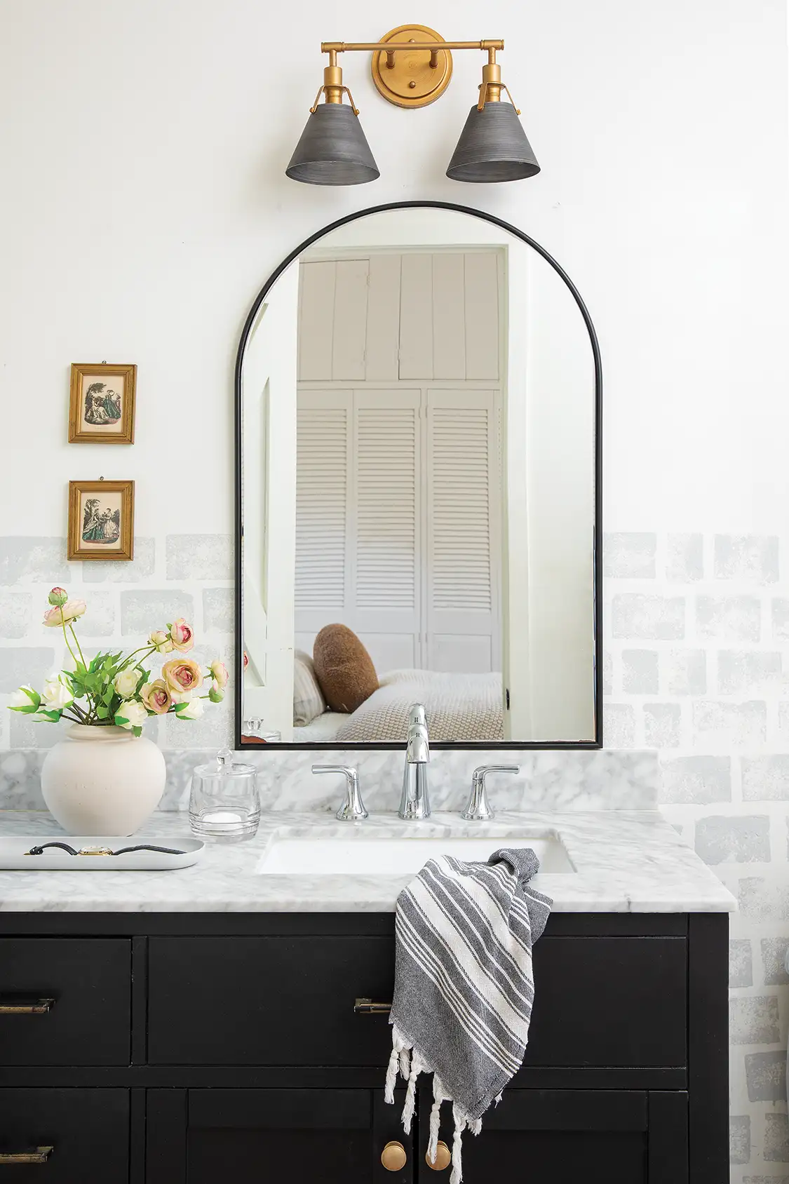 renovated bathroom with gray accent tile and white walls in cozy home with character