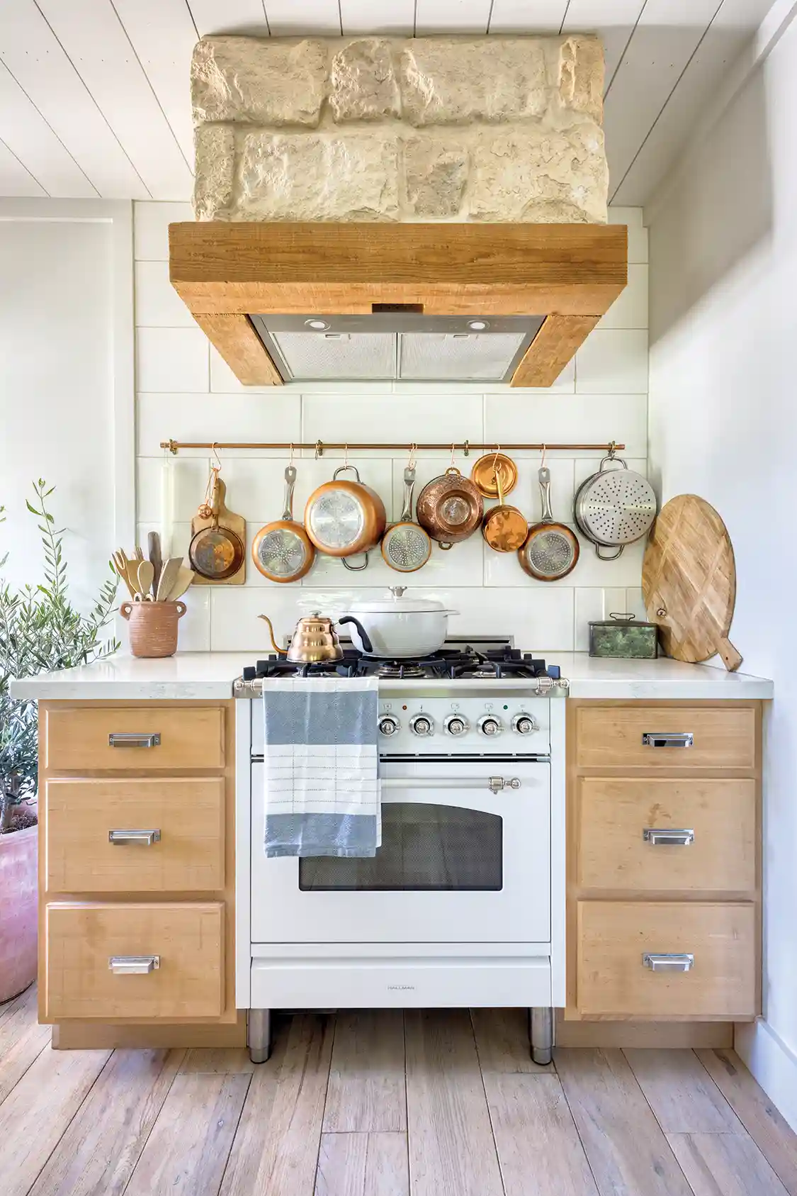hanging pots and pans above range in little house on a large property