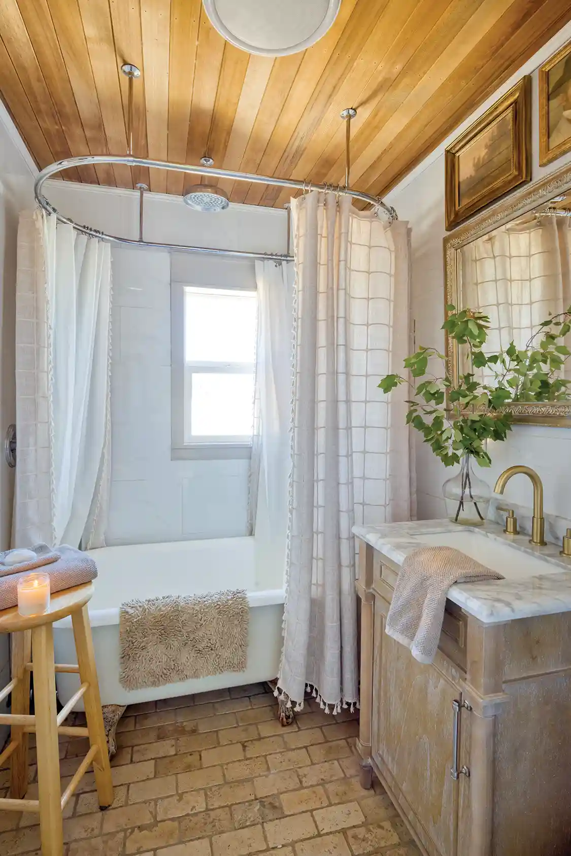 freestanding tub with shower head in ceiling and oblong curtain hanging system
