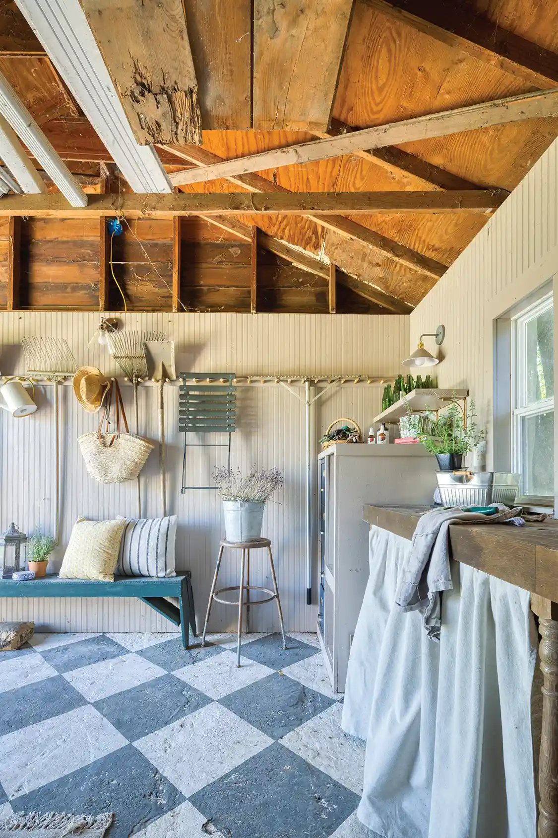 gray and white checkered floor and potting area inside garden shed on Northern California property
