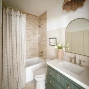 Project House Austin guest bathroom with green vanity and neutral tones