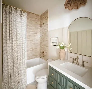 Project House Austin guest bathroom with green vanity and neutral tones