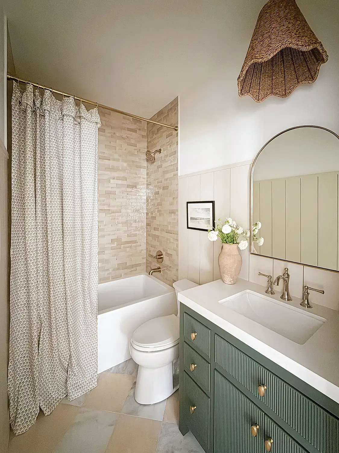 Project House Austin guest bathroom with green vanity and neutral tones