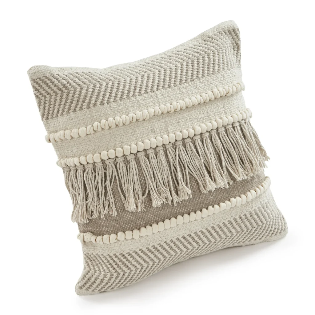 beige throw pillow with tufted row and fringes